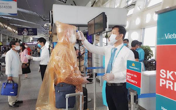 Hành khách phải tuân thủ việc đo thân nhiệt và sát khuẩn tay ở lối vào nhà ga sân bay