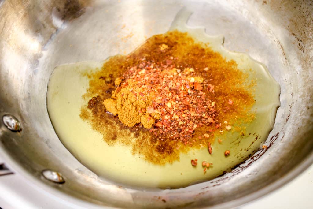 curry powder and chile flakes in oil